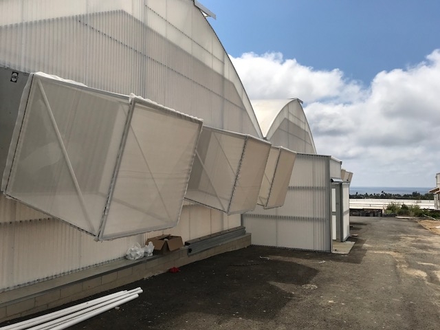 View from outside showing the insect exclusion with lean-to entry vestibules and fan screens.